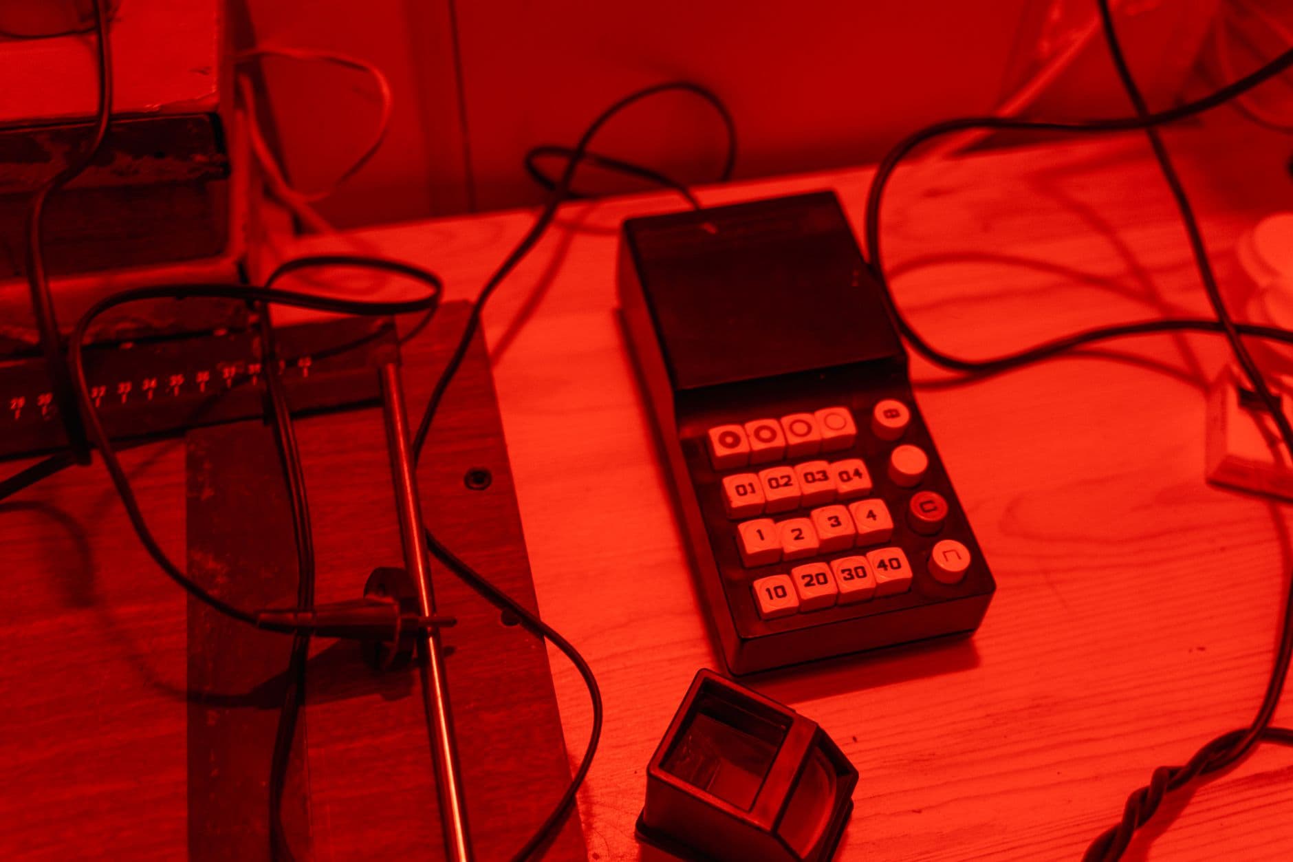 Darkroom workspace with a vintage process timer under red light.