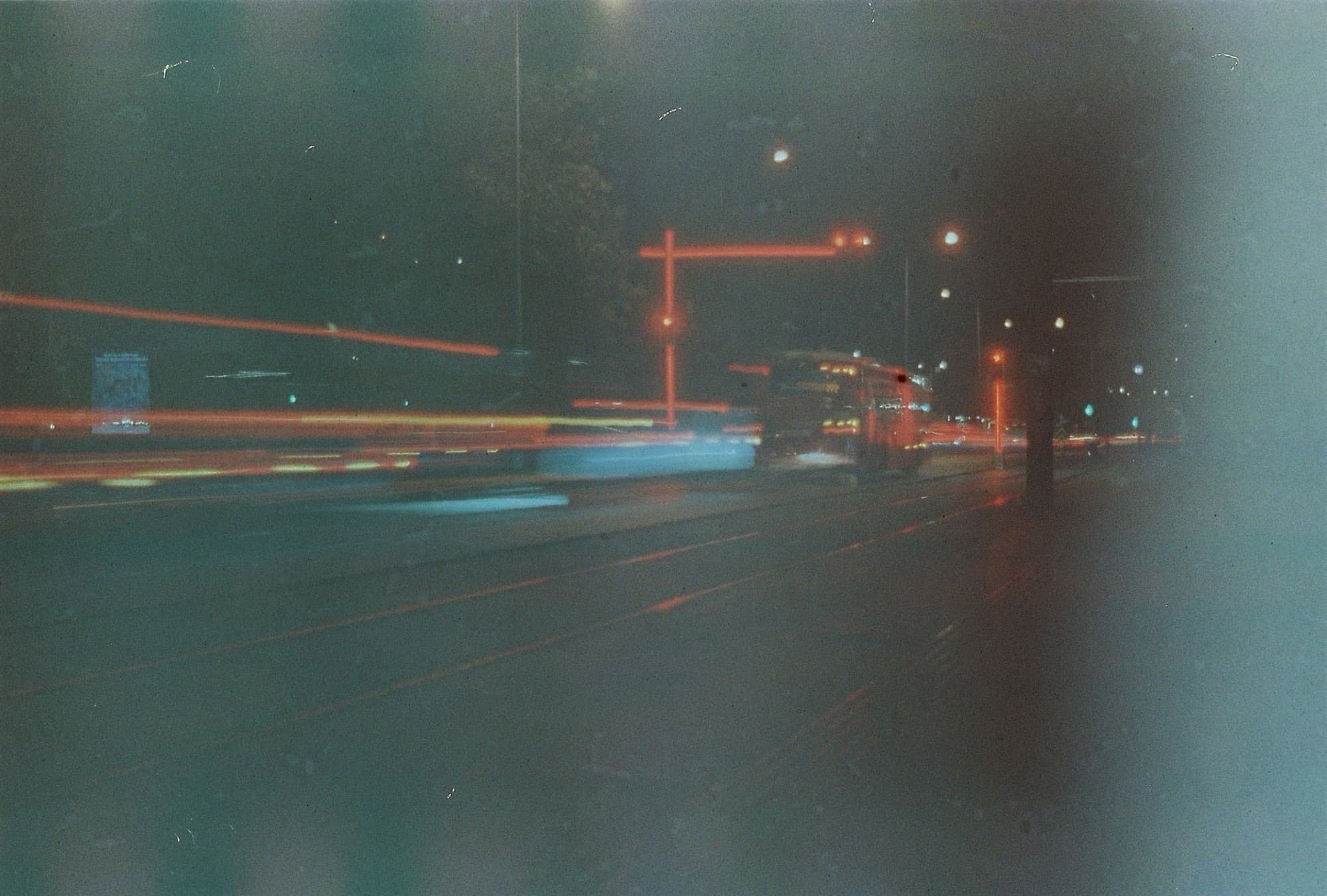 Night street scene with long-exposure light trails.