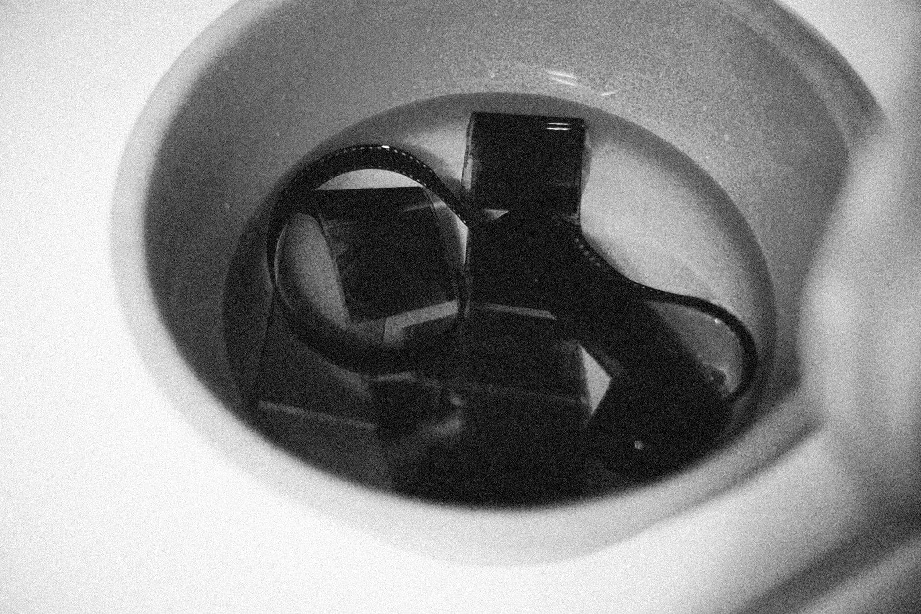 Film negatives soaking in a processing solution.