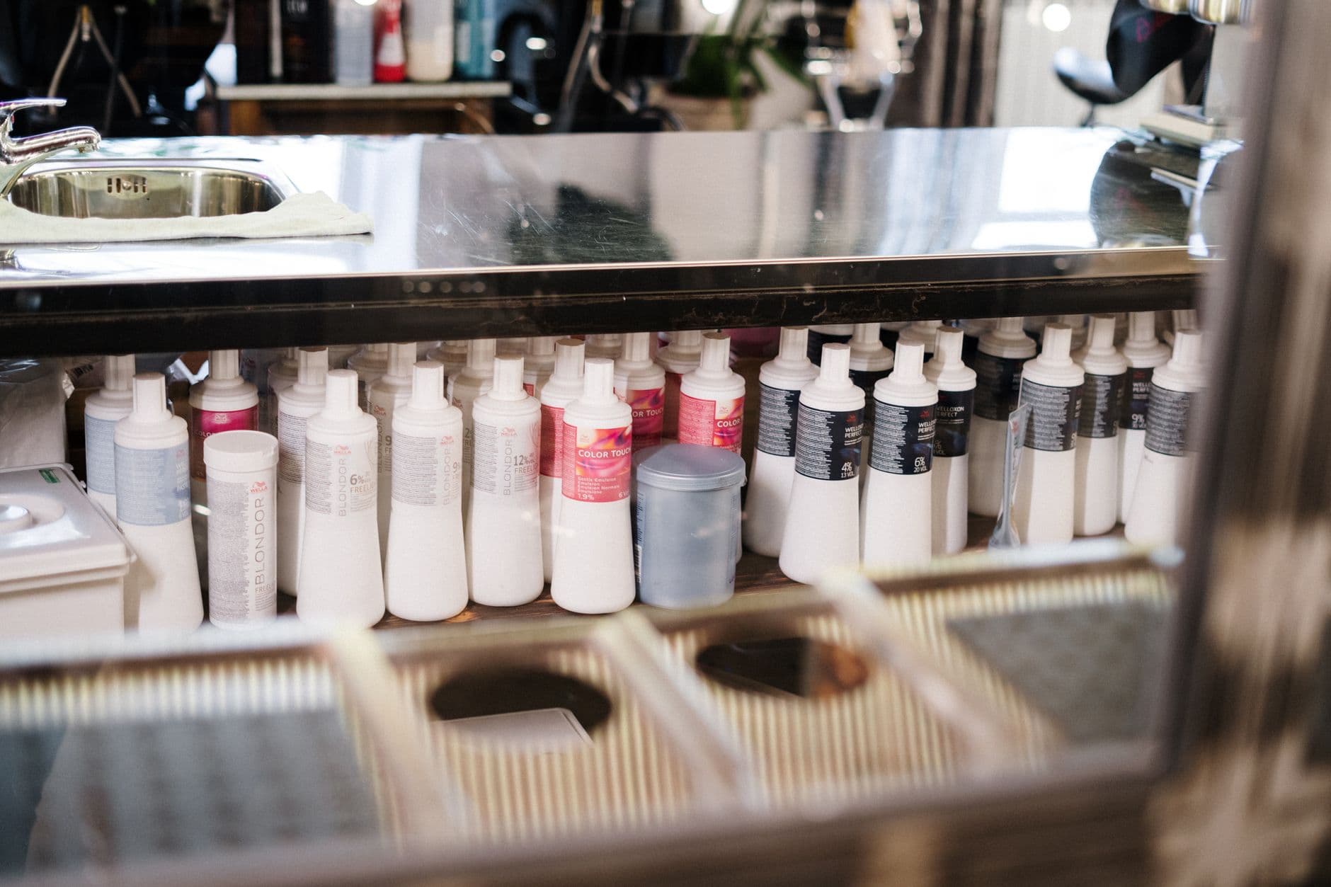 Rows of plastic chemical bottles on a processing rack.